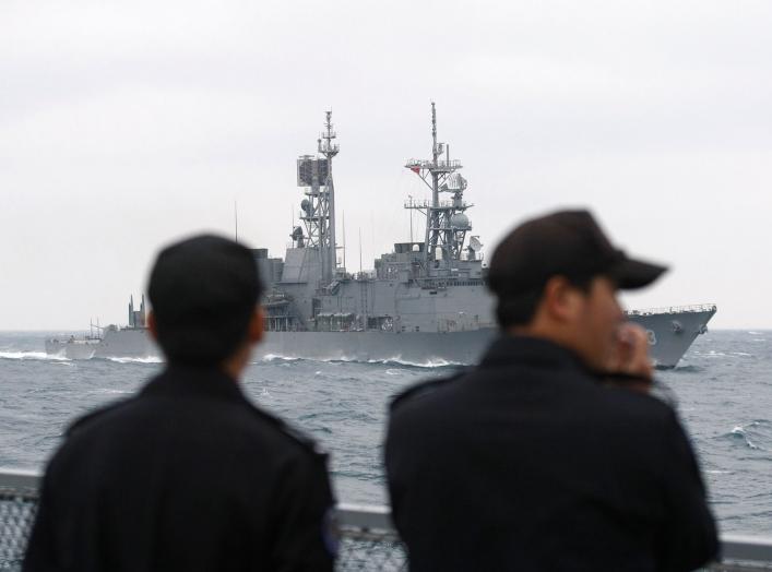 Navy personnel watch a Kidd-class destroyer sailing during a naval exercise outside a navy base in Zuoying, Kaohsiung, southern Taiwan January 21, 2011. REUTERS/Pichi Chuang (TAIWAN - Tags: MILITARY)