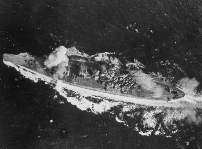 Japanese battleship Yamato is hit by a bomb near her forward 460mm gun turret, during attacks by U.S. carrier planes as she transited the Sibuyan Sea.