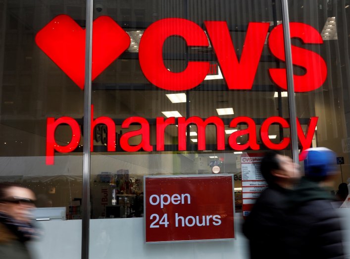 FILE PHOTO: People walk by a CVS Pharmacy store in the Manhattan borough of New York City, New York, U.S., November 30, 2017. REUTERS/Shannon Stapleton/File Photo