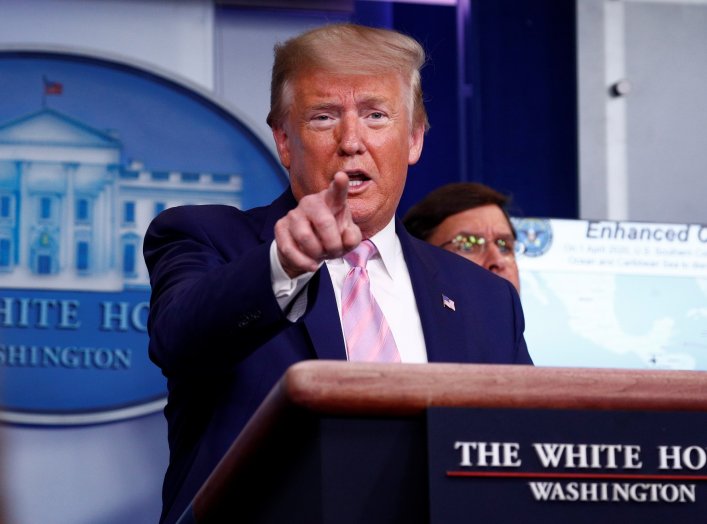 U.S. President Donald Trump speaks as U.S. Defense Secretary Mark?Esper listens during the coronavirus daily briefing at the White House in Washington, U.S., April 1, 2020. REUTERS/Tom Brenner