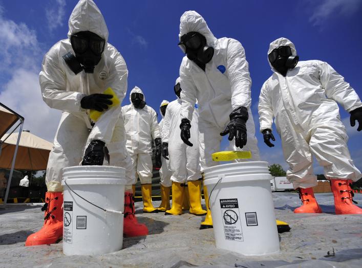 U.S. Soldiers from the 457th Chemical Battalion sponge off their level A protective suits after a simulated nuclear detonation scenario at the Muscatatuck Urban Training Center in Indiana July 19, 2010, during exercise Vibrant Response 10.2. 