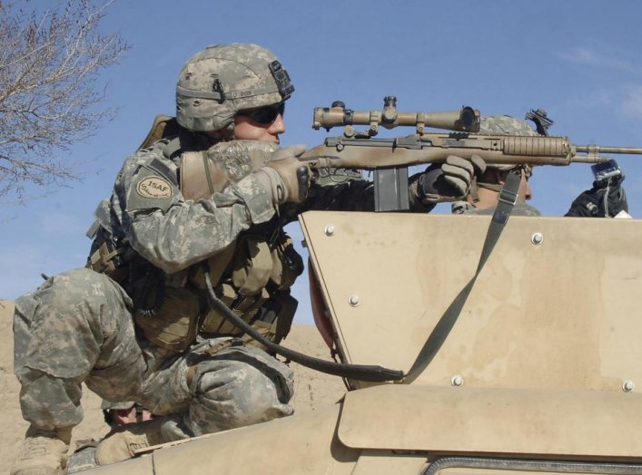 U.S. Army Sgt. Colin Cleek, from Reconnaissance Platoon, 2nd Battalion, 508th Parachute Infantry Regiment, looks through the scope of his rifle onto a mortar range near Ghazni, Afghanistan, on April 1, 2007.   DoD photo by Staff Sgt. Michael L. Casteel, U