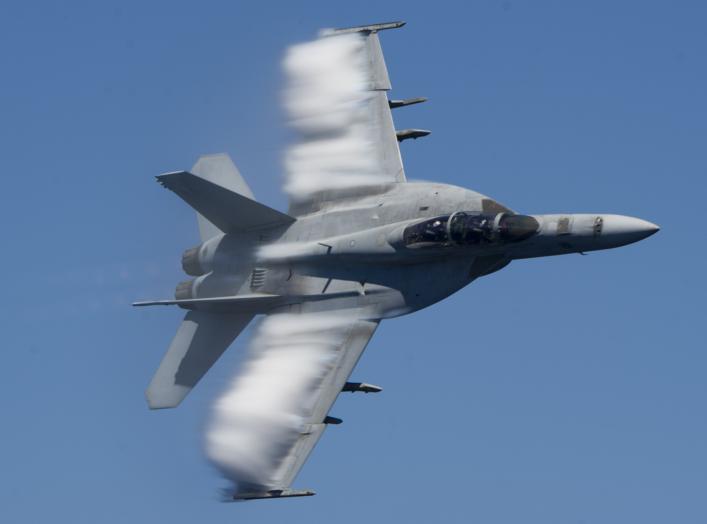  An F/A-18E Super Hornet performs a fly-by during a change of command ceremony for the "Fighting Checkmates" of Strike Fighter Squadron (VFA) 211 aboard the Nimitz-class aircraft carrier USS Harry S. Truman (CVN 75). Harry S. Truman is operating in Comman