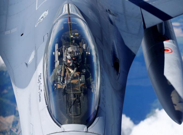 A U.S. Air Force pilot looks at a KC-135 aerial refueling aircraft as he refuels his F-16 fighter during the U.S.-led Saber Strike exercise in the air over Estonia June 6, 2018. REUTERS/Ints Kalnins