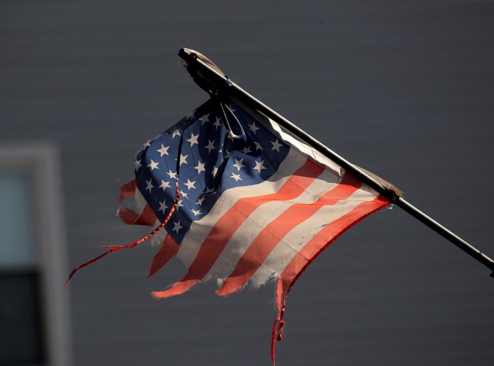 Tattered American flag flies across the street from Wyckoff Heights Medical Center during outbreak of coronavirus disease (COVID-19) in New York