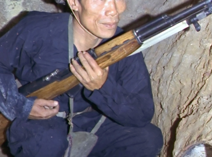 Viet Cong insurgent crouching in a bunker holding an SKS rifle. (U.S. Air Force photo).