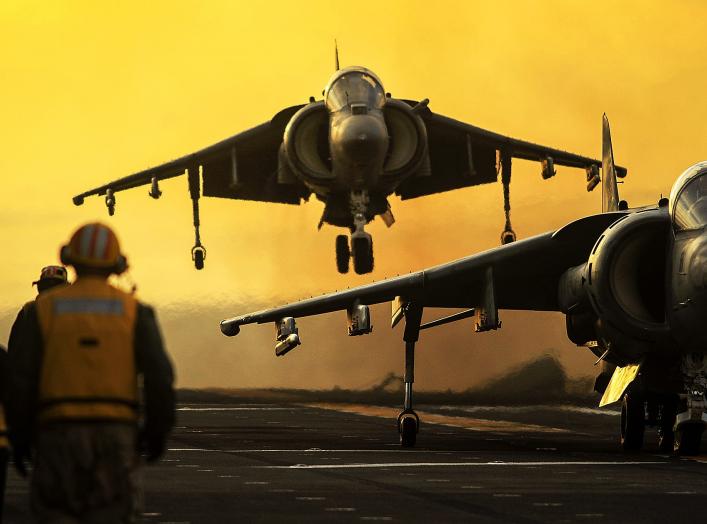 An AV-8B Harrier from Marine Attack Squadron (VMA) 214 performs a vertical take off from the flight deck of the amphibious assault ship USS Boxer (LHD 4).