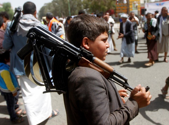 A boy carries a weapon as he and Houthi supporters are seen during a gathering in Sanaa, Yemen April 2, 2020. REUTERS/Mohamed al-Sayaghi