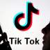 A person holds a smartphone as Tik Tok logo is displayed behind in this picture illustration taken November 7, 2019. Picture taken November 7, 2019. REUTERS/Dado Ruvic/Illustration