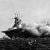  A port bow view of the ship shows her aflame and listing to starboard, 15 September 1942. Men on the flight deck desperately battle the spreading inferno. 