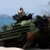 With the USS-Wasp in the background, U.S. Marines ride an amphibious assault vehicle during the amphibious landing exercises of the U.S.-Philippines war games promoting bilateral ties at a military camp in Zambales province, Philippines, April 11, 2019. R