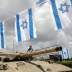 A boy stands atop an old tank during Memorial Day ceremony at Latrun's armoured corps memorial site, Israel May 8, 2019. REUTERS/Corinna Kern