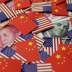 A U.S. dollar banknote featuring American founding father Benjamin Franklin and a China's yuan banknote featuring late Chinese chairman Mao Zedong are seen among U.S. and Chinese flags in this illustration picture taken May 20, 2019. REUTERS/Jason Lee