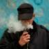 FILE PHOTO: A man poses for a picture, as he vapes at home in La Paz, Bolivia, February 2, 2019. REUTERS/David Mercado/File Photo