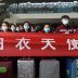 Medical workers from outside Wuhan stand behind a banner with their suitcases as they listen to a speech at the Wuhan Railway Station before leaving the epicentre of the novel coronavirus disease (COVID-19) outbreak, in Hubei province, China 