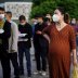 People wearing face masks line up outside Xianning Central Hospital in Xianning, after the lockdown was eased in Hubei province, the epicentre of China's coronavirus disease (COVID-19) outbreak, March 26, 2020. REUTERS/Aly Song