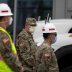 Members of the U.S. Army Corps of Engineers stand outside the Miami Beach Convention Center as they prepare to build a coronavirus field hospital inside the facility, amid the coronavirus (COVID-19) disease outbreak, in Miami Beach, Florida, U.S., April 8