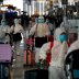 Chinese students living in Thailand wear protective suits as a measure of protection against the coronavirus disease (COVID-19) as they walk at the Suvarnabhumi Airport before boarding a repatriation flight, in Bangkok, Thailand April 21, 2020. REUTERS/Jo