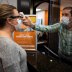 A dentist office manager takes the temperature of a woman as Ohio implements phase one of reopening dentists, veterinarians and elective surgeries, following the outbreak of the coronavirus disease (COVID-19), in Columbus, Ohio, U.S., May 01, 2020. REUTER