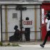 A pedestrian walks past a closed barber shop in Ward 7 as the coronavirus disease (COVID-19) outbreak continues in Washington, U.S., May 8, 2020. REUTERS/Leah Millis