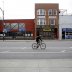 A bicyclist rides past closed businesses in the Wrigleyville neighborhood near the Chicago Cubs home stadium of Wrigley Field, which has been closed due to the coronavirus disease (COVID-19) restrictions in Chicago, Illinois, U.S. May 20, 2020. Picture ta