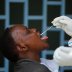 A health worker takes a swab from a woman during mass testing in an effort to stop the spread of the coronavirus disease (COVID-19), in Nairobi, Kenya May 28, 2020. REUTERS/Baz Ratner