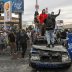 Demonstrators stand on top of a burned out police car during a protest against the death in Minneapolis police custody of George Floyd, in Los Angeles, California, U.S., May 30, 2020. REUTERS/Patrick T. Fallon