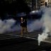 A demonstrator runs after police fired tear gas during a rally amid nationwide unrest following the death in Minneapolis police custody of George Floyd, in Oakland, California, U.S., June 1, 2020. REUTERS/Stephen Lam