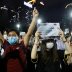 Protesters wearing protective face masks take part in a candlelight vigil to mark the 31st anniversary of the crackdown of pro-democracy protests at Beijing's Tiananmen Square in 1989, after police rejects a mass annual vigil on public health grounds, at 