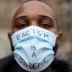 A person wearing a protective face mask attends the Black Lives Matter protest, following the death of George Floyd who died in police custody in Minneapolis, in Birmingham, Britain, June 19, 2020. REUTERS/Carl Recine