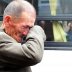 A North Korean man (R) on a bus waves his hand as a South Korean man weeps after a luncheon meeting during inter-Korean temporary family reunions at Mount Kumgang resort October 31, 2010. Kim Ho-Young/Korea Pool via REUTERS