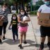 Members of the Rodriguez family carry groceries distributed by the Houston Food Bank for residents affected by the economic fallout caused by the coronavirus disease (COVID-19) pandemic in Houston, Texas, U.S., July 18, 2020. REUTERS/Adrees Latif