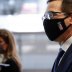 U.S. Treasury Secretary Steve Mnuchin, wearing a face mask, walks with news reporters, following a series of meetings with members of Congress on Capitol Hill in Washington, U.S. July 21, 2020. REUTERS/Tom Brenner
