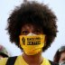 A protester with the "Black Lives Matter" slogan printed on her face mask joins a protest against racial inequality and police violence in Portland, Oregon, U.S., July 26, 2020. REUTERS/Caitlin Ochs