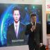 Xinhua news anchor Qiu Hao stands next to an AI virtual news anchor based on him, at a Sogou booth during an expo at the fifth World Internet Conference (WIC) in Wuzhen town of Jiaxing, Zhejiang province, China November 7, 2018. Picture taken November 7, 