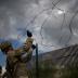The border wall is seen in the background as U.S. Army soldiers install concertina wire along the United States - Mexico border in Hidalgo, Texas, U.S., November 8, 2018. Picture taken on November 8, 2018. REUTERS/Adrees Latif