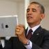 U.S. President Barack Obama holds up an Apple iPad during a visit to Buck Lodge Middle School in Adelphi, Maryland February 4, 2014.