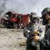 Soldiers of the People's Liberation Army anti-chemical warfare corps work next to a damaged firefighting vehicle at the site of Wednesday night's explosions at Binhai new district in Tianjin, China, August 16, 2015.