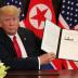 U.S. President Donald Trump shows the document, that he and North Korea's leader Kim Jong Un signed acknowledging the progress of the talks and pledge to keep momentum going, after their summit at the Capella Hotel on Sentosa island in Singapore June 12, 