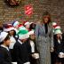 U.S. first lady Melania Trump poses with a children choir after joining local school students and U.S. Marines stationed at the U.S. Embassy, wrapping holiday presents to be donated to the Salvation Army, at the Salvation Army Clapton Center