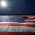 As 95-by-50-foot American flag is unfurled on the side of an apartment complex, a replica of the "The Great Flag" that was spun, woven, dyed, constructed and displayed on the same building by Amoskeag Manufacturing Company in 1914, in Manchester, New Hamp