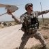 Army 1st Lt. Steven Rose launches an RQ-11 Raven unmanned aerial vehicle near a new highway bridge project along the Euphrates River north of Taqqadum, Iraq, Oct. 9, 2009. U.S. Army photo by Spc. Michael J. MacLeod  