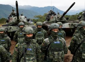 Taiwanese soldiers stand in front of a M60A3 tank during a military drill in Hualien, eastern Taiwan, January 30, 2018. REUTERS/Tyrone Siu