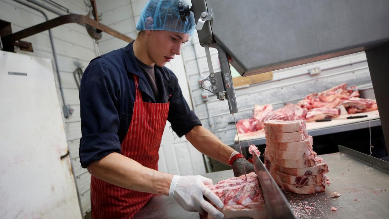 Butcher Gerald vande Bruinhorst works on a beef carcass as part of his uncle’s business which allows farmers to circumvent the supply chain blockage caused by coronavirus disease (COVID-19) outbreaks at meatpacking plants, in Picture Butte, Alberta, Canad