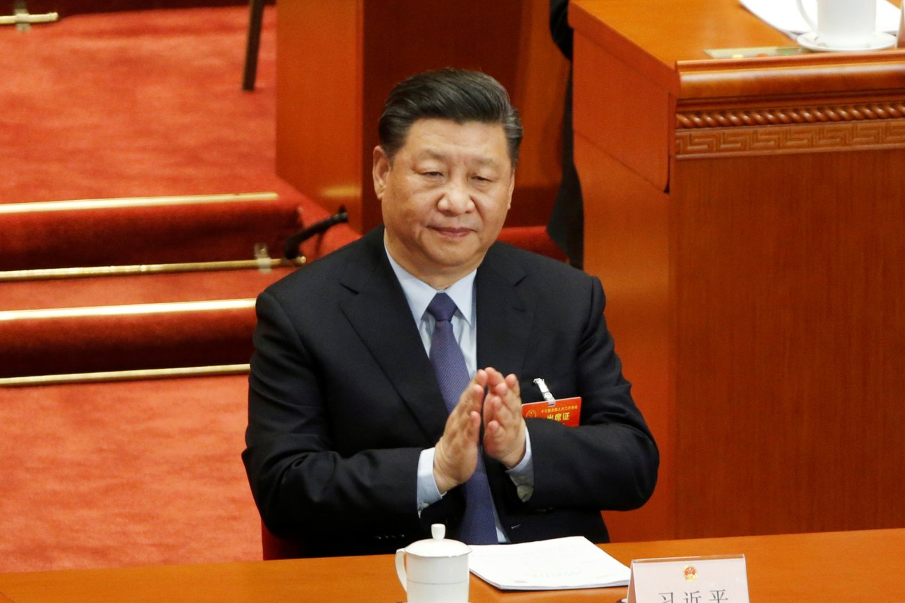 Chinese President Xi Jinping claps his hands at the second plenary session of the National People's Congress (NPC) at the Great Hall of the People in Beijing, China March 8, 2019. REUTERS/Thomas Peter